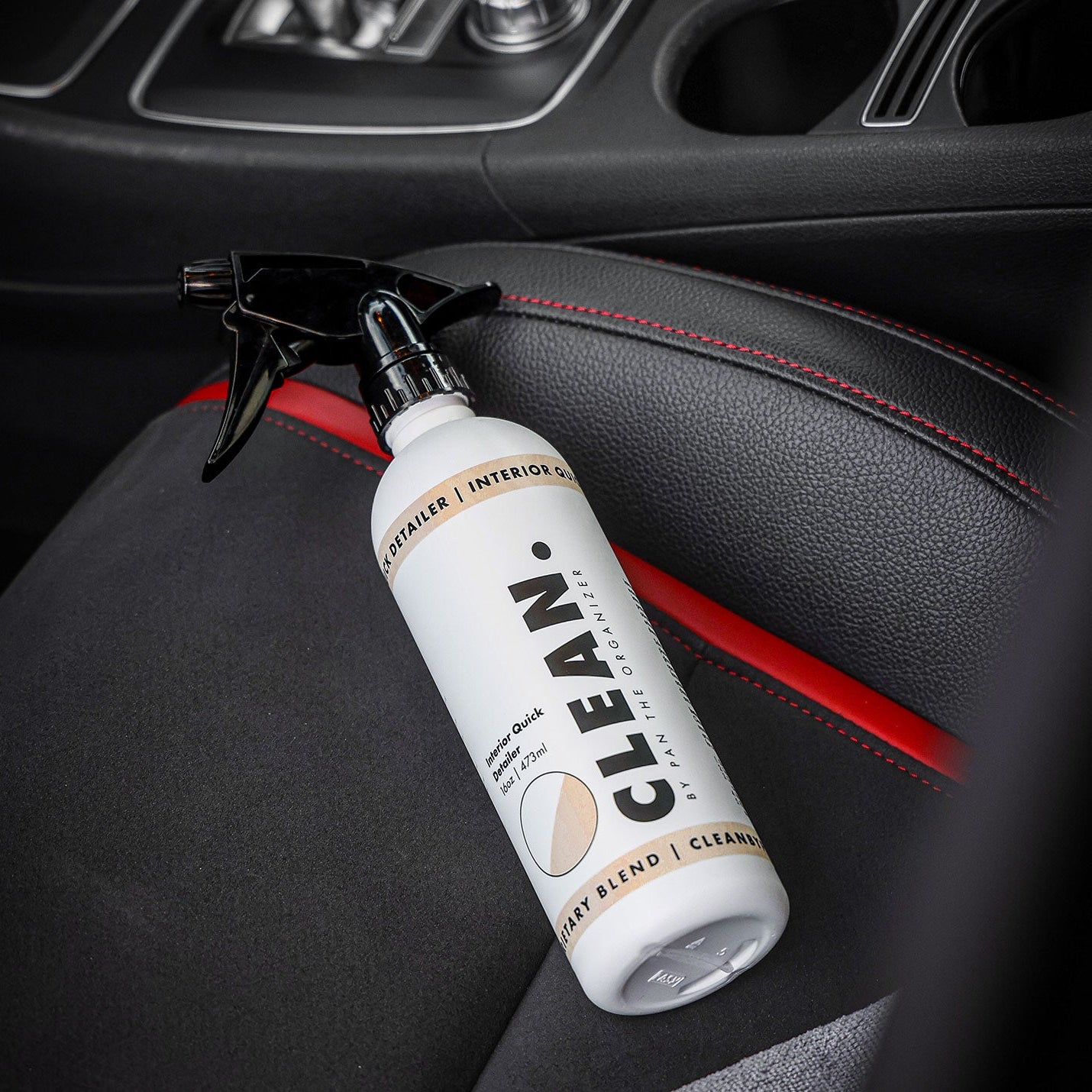 CKEAN. by Pan interior cleaning spray bottle on a car seat