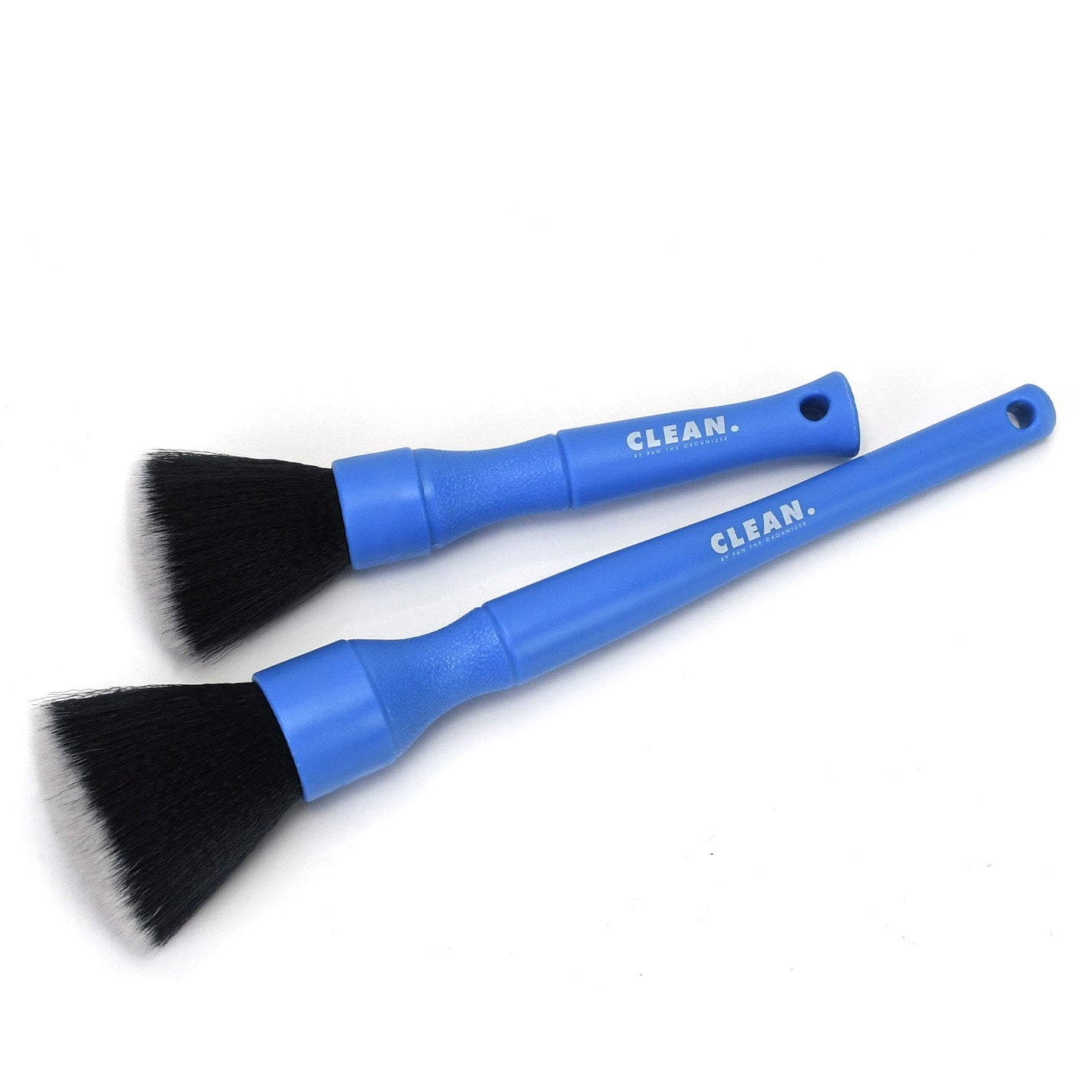 Two blue CLEAN. by Pan cleaning brushes with black bristles on a white background