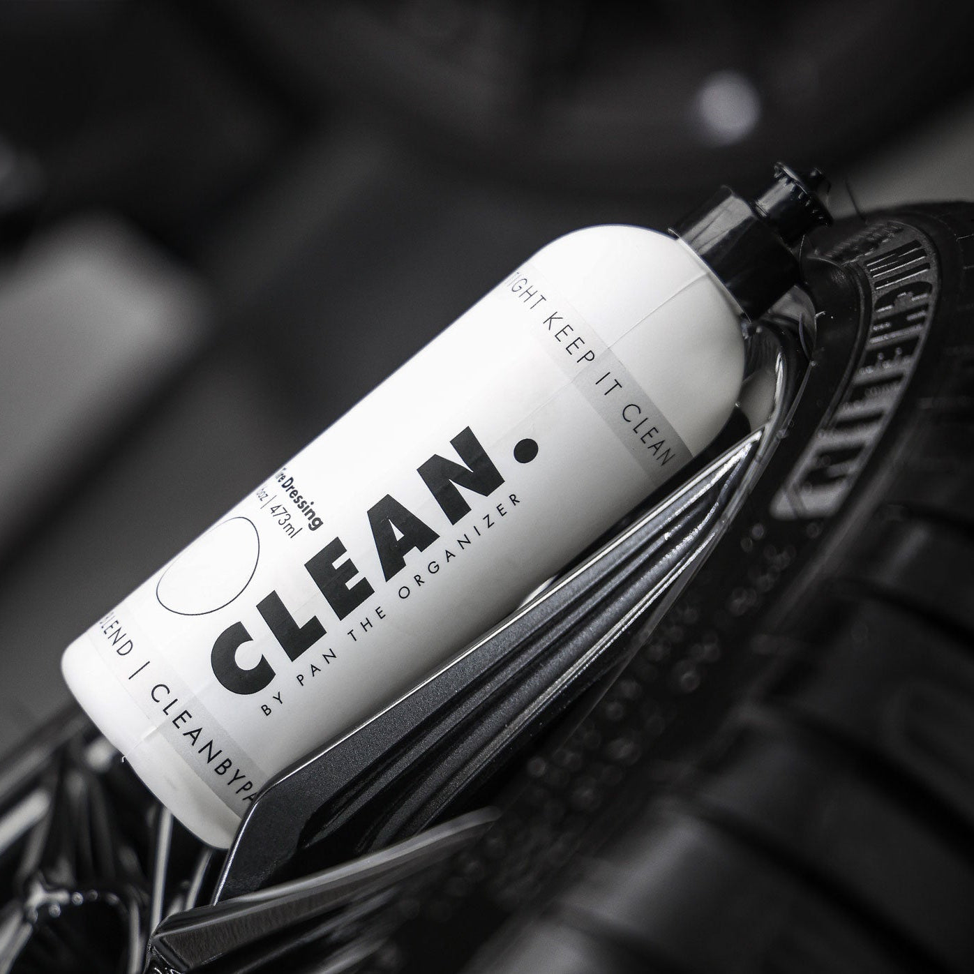 Tyre Dressing product labelled 'Clean. by Pan' attached to a car tire rim.