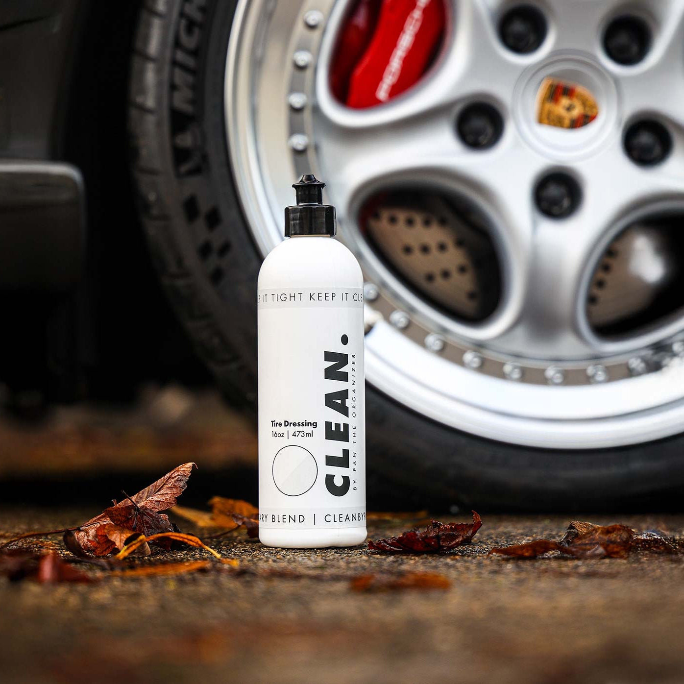 CLEAN. by Pan Tyre dressing bottle with car wheel in the background